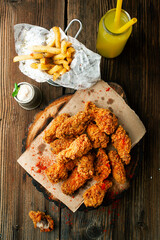 Crispy BBQ chicken wings with sauce and chili peppers and fries - 433821823
