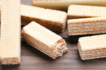 Sweet wafer sticks on brown wooden background