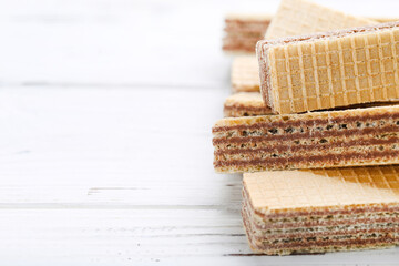 Sweet wafer sticks on white wooden background