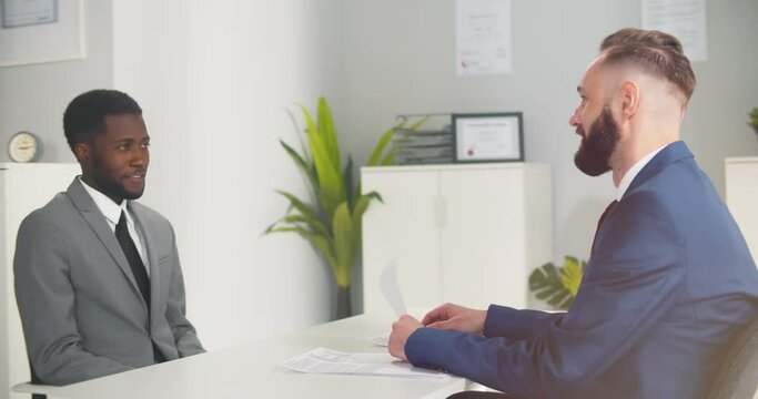 Young afro-american male candidate smiling at job interview