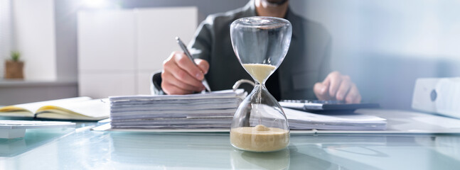 Hourglass In Office. Crunch Time