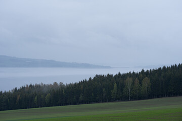 Lake Mjøsa in rain and fog at spring.