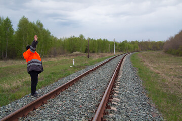 Railroad worker foreman supervises repair of road tracks