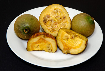 Fruits of jenipapo, a typical Brazilian fruit, cut showing the interior of the ripe fruit