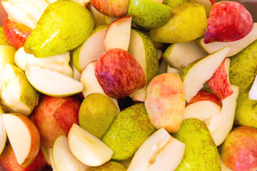 Sliced apples and pears as background, texture, pattern.