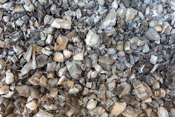 Ashes formed after burning firewood as a background, texture, pattern.