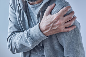 Shoulder joint pain, man with severe ache as symptom of osteoarthritis