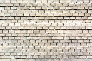 Beautifully and evenly laid gray brick wall as a background, texture, pattern.