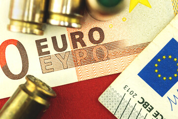 Europe Union criminal and money background, bullet for a gun on Euro banknotes close-up, concept of...