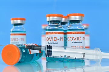 Ampoules with sars-cov-2 vaccine and syringe injection.