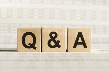 Q&A abbreviation - questions and answers, on wooden cubes on a light background.