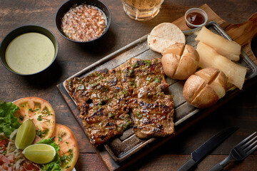 grilled beef steak with potato and salad