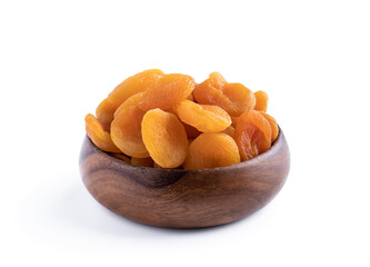 Dried apricots in wooden bowl isolated on white