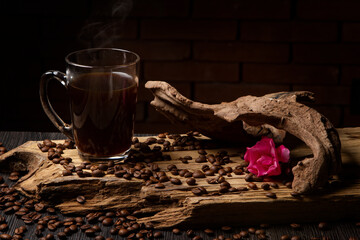 Cup of coffee on a rustic wood. Coffee grains.