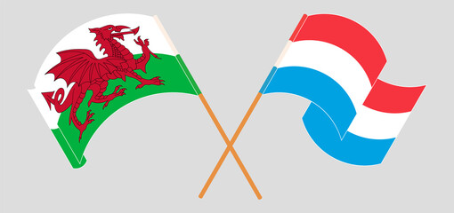 Crossed and waving flags of Wales and Luxembourg