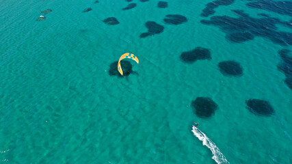 Fototapeta premium Aerial drone photo of kite surfer practise in tropical exotic island bay with emerald crystal clear sea