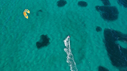 Aerial drone photo of kite surfer practise in tropical exotic island bay with emerald crystal clear sea - obrazy, fototapety, plakaty