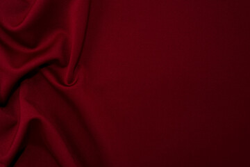 Part of the dark fabric texture of the fabric for the background and decoration of the work of art, a beautiful crumpled pattern of silk or linen. A crumpled piece of cloth