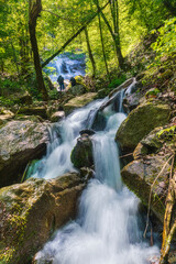 Mountain waterfall in spring forest
