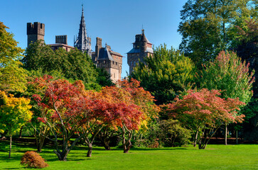 Towers of Cardiff castle from Bute park with trees in autumn colours