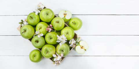 Apples fruits green apple fruit box on wooden board banner copyspace copy space with leaves and blossoms