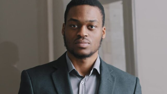 Young African American lawyer in suit man standing in office waving index finger showing NO gesture. People rights protection, domestic violence abuse rejection, no discrimination, keep distance 