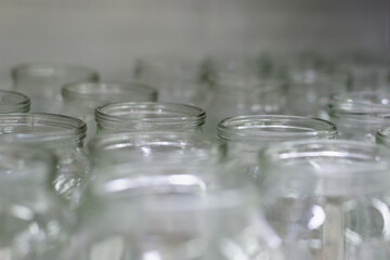 Glass jars without lids on the shelf.