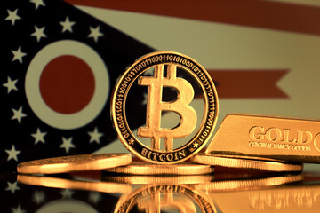 Physical version of Bitcoin, gold bar and Ohio State Flag.