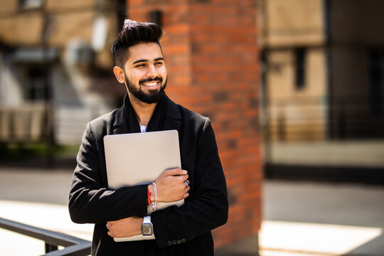 Young Indian Man Walking Outdoors Near Business Office