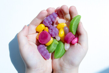hands holding colorful candies