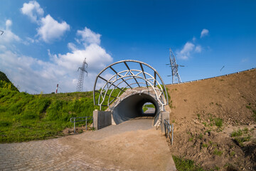 round tunnel footpath on blue sky background