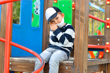 Fototapeta na wymiar A cute four year old preschooler is having fun on the playground.