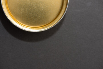 close up of an isolated golden metallic tin container viewed from above