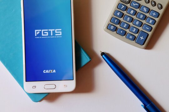 Bahia, Brazil. September 18, 2020:  Severance Indemnity Fund for employees (FGTS - Fundo de Garantia do Tempo de Servi&ccedil;o). / Brazilian special fund designated for workers. FGTS app on smartphone.