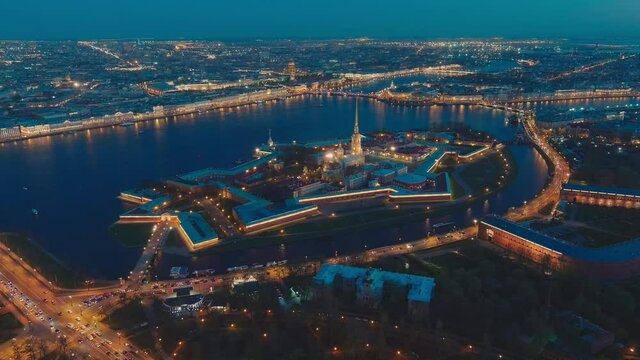 Drone flies up fast to the Peter and Paul cathedral and fortress at evening, the sights of St. Petersburg, the Neva river, the Hermitage museum, Rostral columns, bridges, St. Isaac cathedral