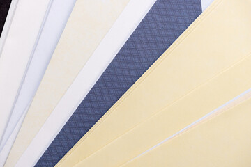 various shades of yellow cream white and blue envelopes overlapping
