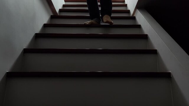 The husband was walking the stairs in anger. Going to hurt his wife , Concept of domestic violence