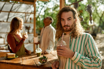 Portrait of young caucasian man drinking juice
