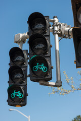 bicycle traffic light against a blue sky background - indicating green thus instructing cyclists to...