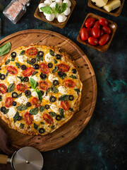 Pizza. View from above. Located on a beautiful platter. The vibrant pizza ingredients create a...