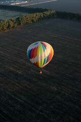 Single air hot balloon above fields