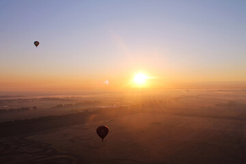 Balloon in front of the sun during sunset