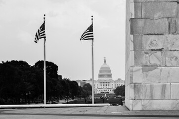 United States flags next to Washington monument and US Capitol Building - Washington DC United States