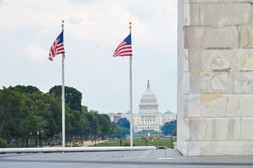 United States flags next to Washington monument and US Capitol Building - Washington DC United...