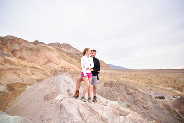 A family with a teenage girl is hiking Dante’s View trail in Death Valley National Park in California, USA during their road trip from Las Vegas to San Francisco in March 2021 during COVID-19 pandemic