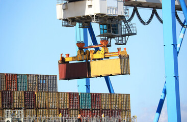 Shipping Container Gantry Cranes Lifting at a container terminal. Loading / unloading cargo ship.