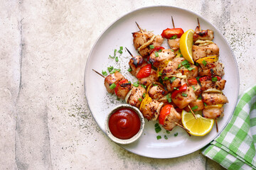 Chicken kebab skewers on a plate . Top view with copy space.