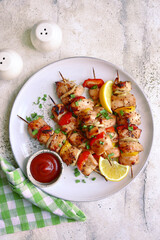 Chicken kebab skewers on a plate . Top view with copy space.
