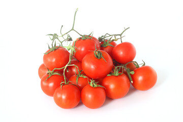 Red tomatoes of fresh harvest on a branch on an isolated white background, top view