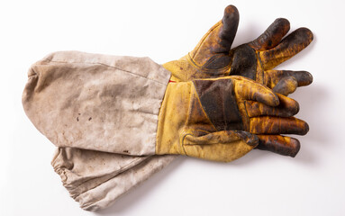 Old dirty yellow beekeeping gloves